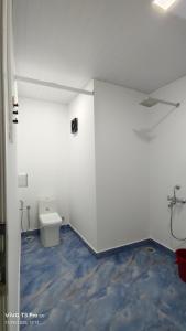 ein weißes Bad mit WC im Zimmer in der Unterkunft Baywatch Beach Resort patnem in Canacona