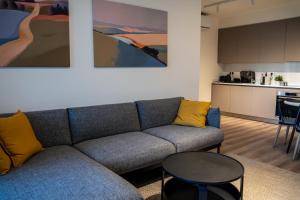 a living room with a couch and a table at Luxe One Residence in Aglantzia