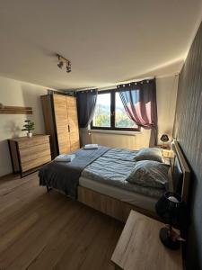 una camera da letto con un letto grande e una finestra di Apartament Gór-SKI a Malinka
