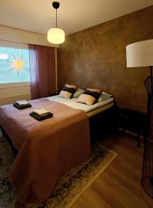 a bedroom with a large bed and a window at Bright Elegant - Feel Lapland with light & harmony in Rovaniemi +24 photos