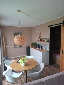 a living room with a table and chairs and a kitchen at B&B De Terpen in Dokkum