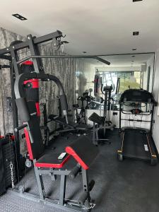 a gym with several treadmills and other equipment at Shortletbylolami in Mama