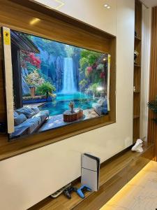 a waterfall painting on a wall in a room at Shortletbylolami in Mama