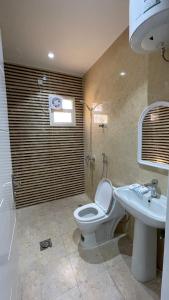 a bathroom with a toilet and a sink at غرفه - واڤا in Tabuk
