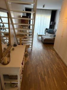 a living room with a spiral staircase and a couch at A 15 min de l'entrée de Bruxelles in Rixensart