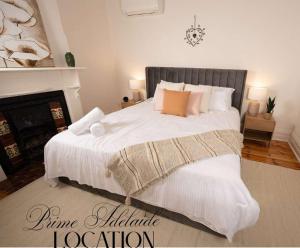 a bedroom with a large bed with white sheets and pillows at The Arches- Beautiful 3-Bedroom Family Stay Near Adelaide Oval, City Events and Amazing Dining in North Adelaide
