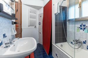 a bathroom with a sink and a shower at La stanza Modicana in Modica