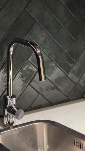 a kitchen sink with a faucet on a counter at memore in Mons