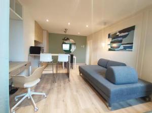 a living room with a blue couch and a table at memore in Mons