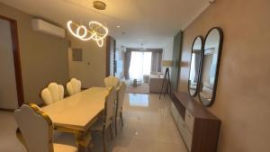 a dining room with a table and chairs and a mirror at Sea View Apartment in Colombo -Dehiwala in Dehiwala