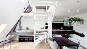 a white staircase in a room with a table and chairs at memore in Mons