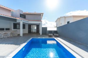 a swimming pool in the backyard of a house at Breeze House 1 by Atlantic Holiday in Garajau
