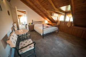 a bedroom with a bed and a table and chairs at Ourdreamhouses Lake Hereou Loutraki in Vouliagmeni Lake +44 photos