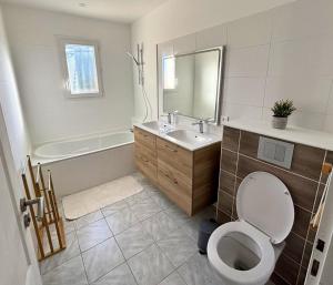 a bathroom with a toilet and a sink and a tub at Maison cosy avec SPA privatif à 13 min du Futuroscope in Beaumont +37 photos