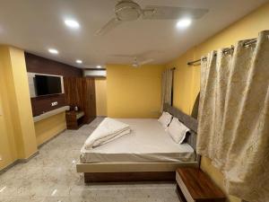 a bedroom with a bed and a television in it at Velora Stays in Kolkata