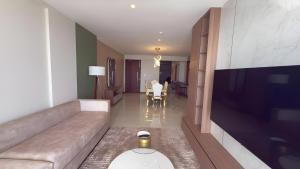 a living room with a couch and a television at Sea View Apartment in Colombo -Dehiwala in Dehiwala