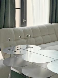 two tables in front of a white couch at memore in Mons