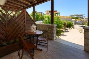 a patio with a table and chairs and a building at Levanta Cozy Apartment #1 in Kalavarda Rhodes in Kalavárda +3 photos