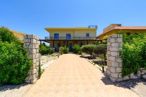 a house with a stone pathway in front of it at Levanta Cozy Apartment #1 in Kalavarda Rhodes in Kalavárda