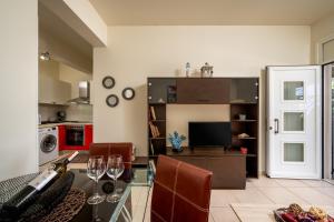 a living room with a glass table with wine glasses at Levanta Cozy Apartment #1 in Kalavarda Rhodes in Kalavárda