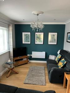 a living room with a couch and a tv at Mill Pond View in Pembroke