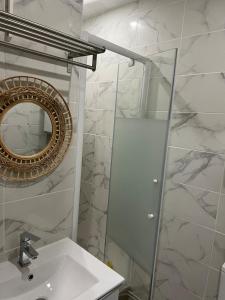 a white bathroom with a mirror and a sink at Studio Bourgogne 30 in Orléans +7 photos