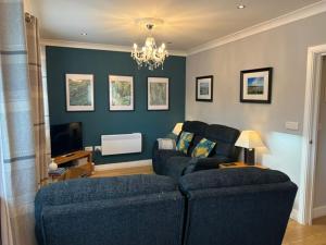 a living room with a couch and a tv at Mill Pond View in Pembroke +17 photos