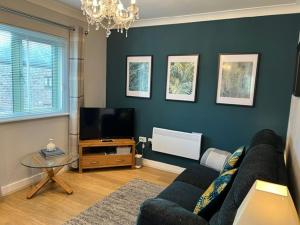 a living room with a couch and a tv at Mill Pond View in Pembroke