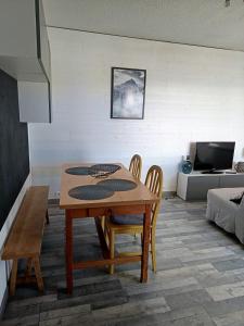 a dining table and chairs in a living room at Cozy 1-room apartment with veranda and parking in Font-Romeu