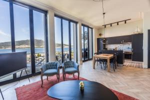 a kitchen and living room with a view of the ocean at Santa Tecla - Safira in Caminha