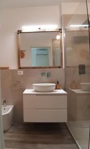 a bathroom with a sink and a mirror at Catia's Apartments, Clima, Mare&Spiaggia 700mt in Porto San Giorgio +17 photos