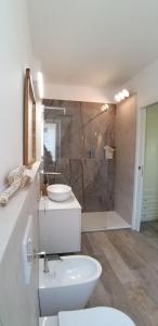 a bathroom with a toilet and a sink and a shower at Catia's Apartments, Clima, Mare&Spiaggia 700mt in Porto San Giorgio