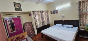 マイソールにあるBhuvi farmsのベッドルーム1室(ベッド1台付)、紫のドア