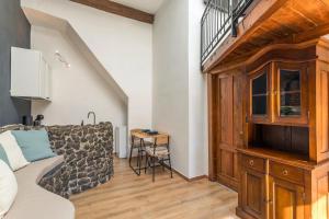 a living room with a couch and a table at Gesuiti Home - Lumina Collection in Catania