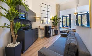 a living room with a couch and some plants at ºIM La Latina-City Centre-WiFi-AC-SmartTVº in Madrid