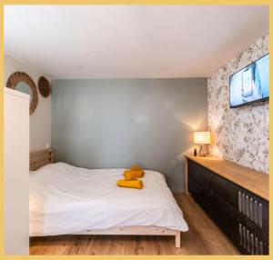a bedroom with a teddy bear sitting on a bed at Chez Mathieu I Studio I Sauverny in Sauverny