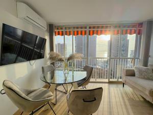 a living room with a glass table and chairs at Albatros 13º in Benidorm