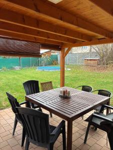 a wooden table and chairs on a patio at Apartmány Ševcovská in Zlín
