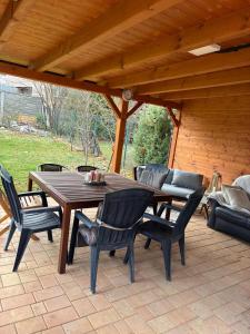 a wooden table and chairs on a patio at Apartmány Ševcovská in Zlín
