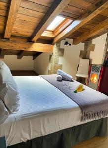 a large white bed in a room with wooden ceilings at Apartamentos Spa Casco Histórico de Isla in Isla +38 photos