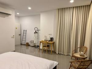 a bedroom with a bed and a table and chairs at Reatrey Inn in Phnom Penh