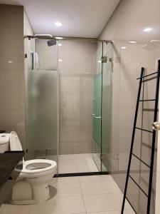 a bathroom with a toilet and a glass shower at Reatrey Inn in Phnom Penh