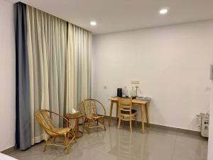 a dining room with a table and chairs in a room at Reatrey Inn in Phnom Penh