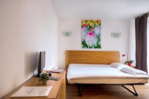 Postel nebo postele na pokoji v ubytování Zenitude Hôtel-Résidences Les Portes d'Alsace