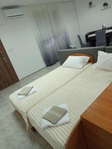 two beds in a room with towels on them at Alena'Studio in Gabrovo +3 photos