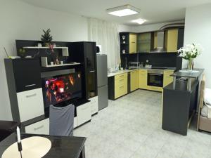 a large kitchen with a fireplace in the middle at Alena'Studio in Gabrovo