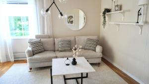 a living room with a couch and a table at Landhaus Måsberget in Kristinehamn