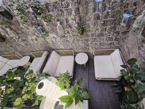 an overhead view of a patio with white lounges and plants at memore in Mons