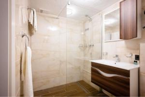 a bathroom with a sink and a shower at Ferienwohnung Mimosa 302 in Wiggensbach