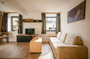 a living room with a couch and a coffee table at Ferienwohnung Mimosa 302 in Wiggensbach +10 photos